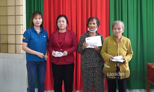 Phóng viên Báo Lao Động trao tiền ủng hộ của bạn đọc đến các hoàn cảnh. Ảnh: Xuân Nhi