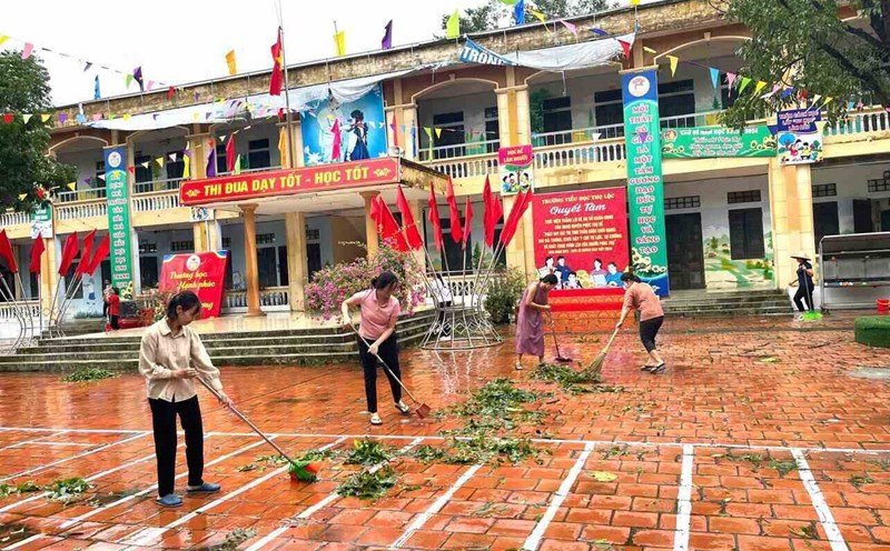Cán bộ, đoàn viên Công đoàn huyện Phúc Thọ dọn dẹp, khắc phục hậu quả bão số 3 tại xã Thọ Lộc. Ảnh: CĐCS