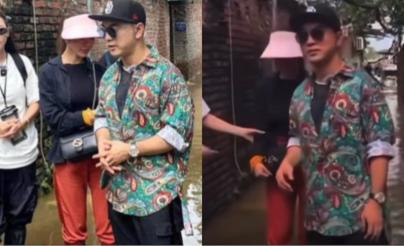 Vợ chồng ca sĩ Ưng Hoàng Phúc đi trao quà ở khu dân cư Phúc Tân, Hoàn Kiếm, Hà Nội. Ảnh: Cắt từ video fanpage Bí mật Showbiz