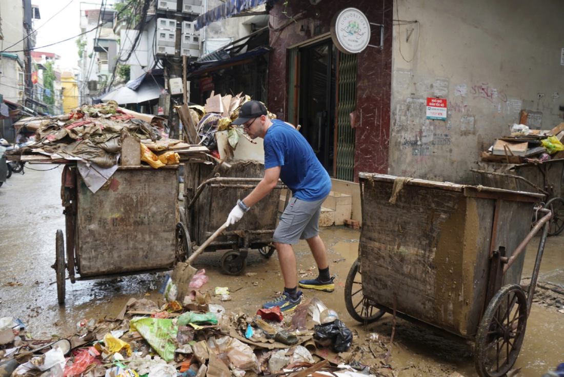 Anh Bob Little hỗ trợ người dân Hà Nội dọn dẹp đường phố. Ảnh: Công Hòa