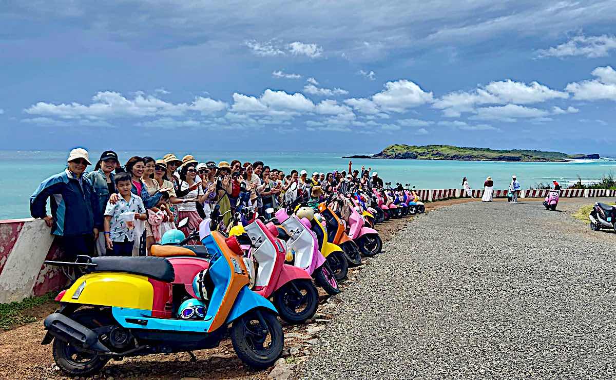 A group of tourists take photos at Phuot slope, Phu Quy island. Photo: Long Vi