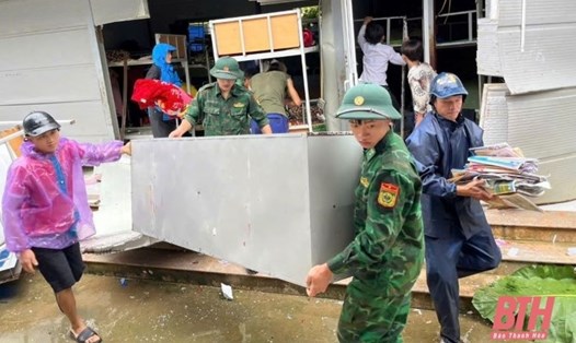 Cán bộ, chiến sĩ biên phòng hỗ trợ người dân huyện Mường Lát sơ tán đến nơi an toàn. Ảnh: Trần Lâm