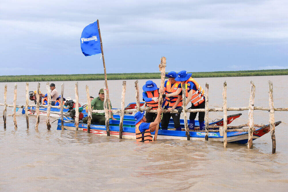 Doan nhan vien Vinamilk cung thuc hien gia co, sua chua hang rao khoanh nuoi rung. Ảnh: Vinamilk