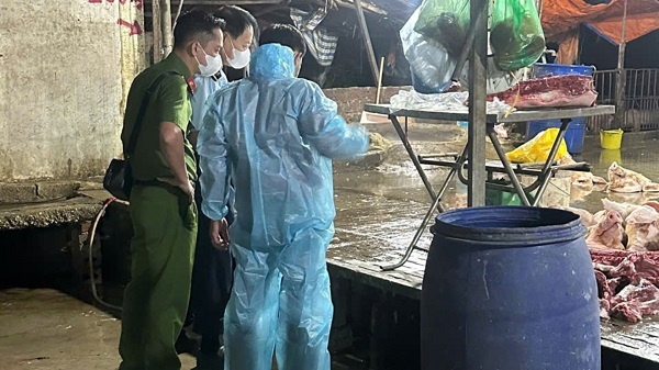 Lực lượng chức năng kiểm tra và lấy mẫu thịt lợn đi xét nghiệm. Ảnh: Đạt Lê