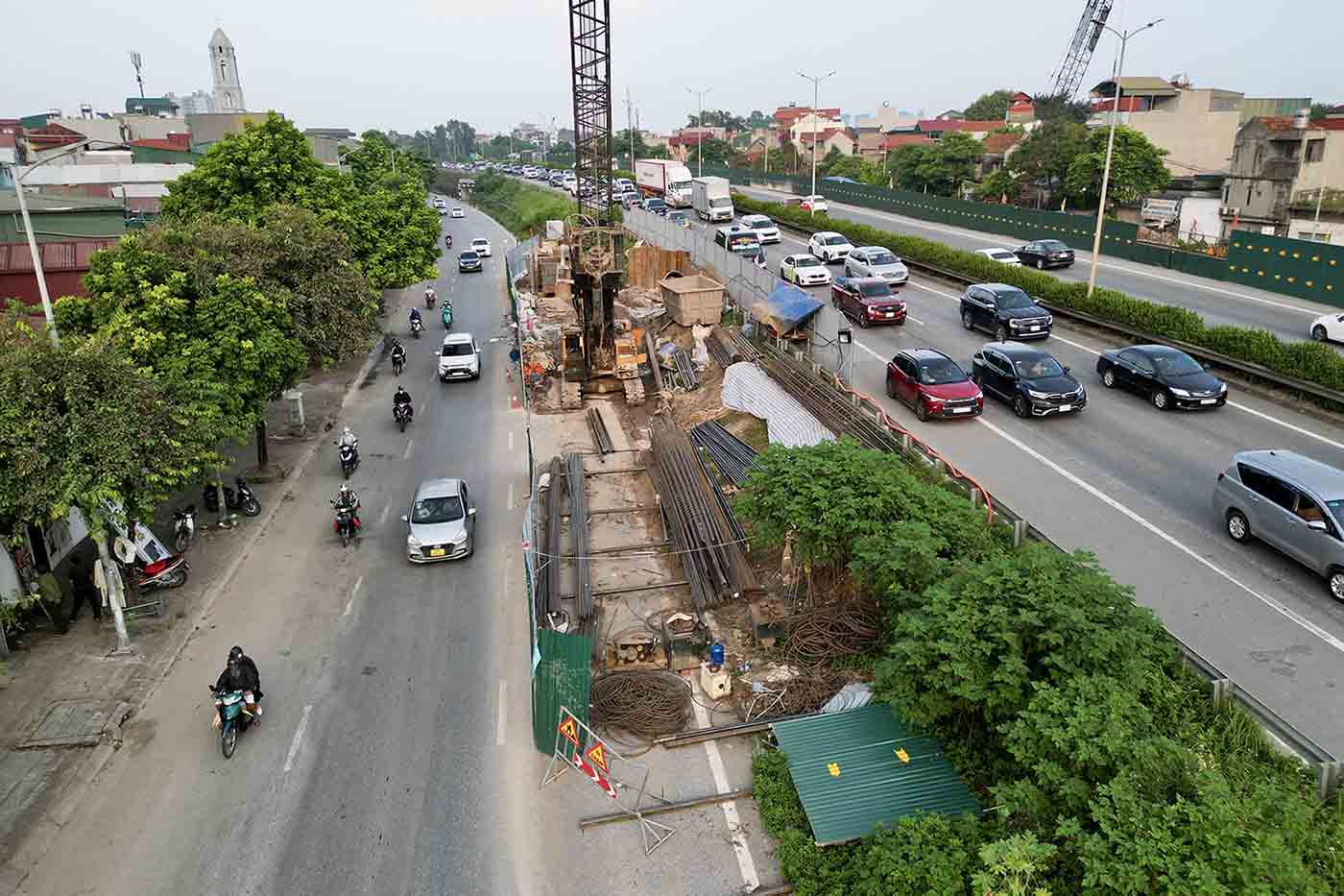 Hàng rào chắn được dựng lên trên Vành đai 3 phục vụ thi công khiến một phần mặt đường bị thu hẹp, việc đi lại của người dân gặp khó khăn. Ảnh: Hữu Chánh