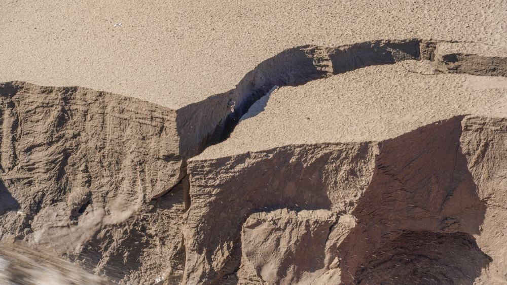 The sea sand has been washed salty at the point of transfer to the ship's side.