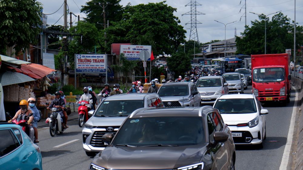 On Highway 1, the western gateway to Ho Chi Minh City, traffic is congested, with many vehicles moving slowly.