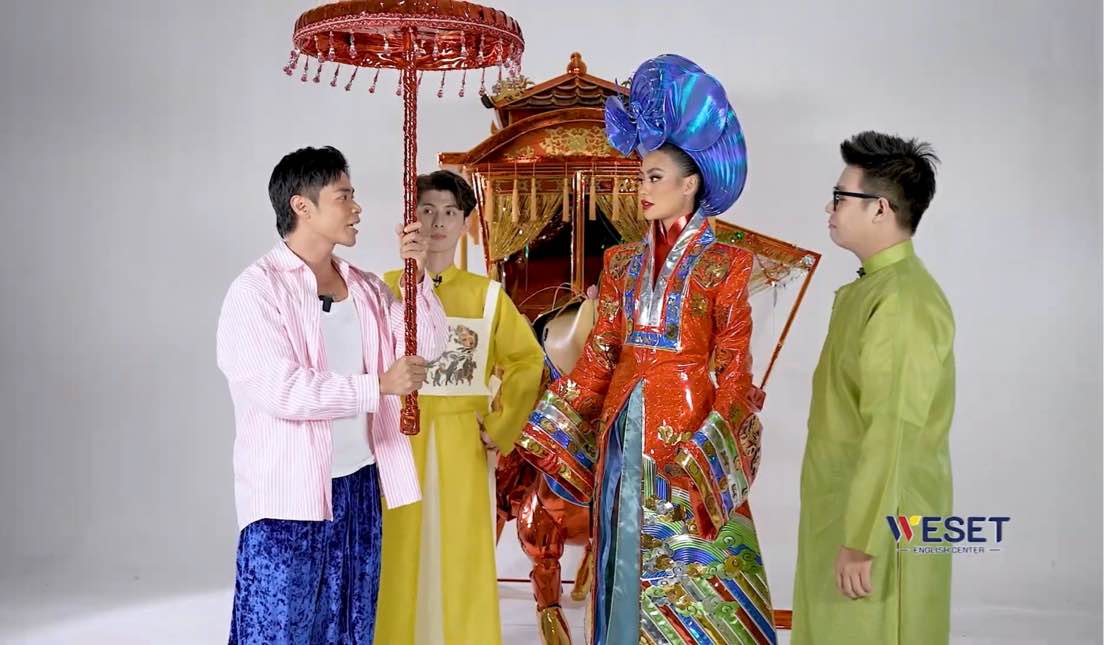 Designers Nguyen Minh Cong and Nguyen Hung Bao assist Xuan Hanh in trying on clothes. Photo: NVCC