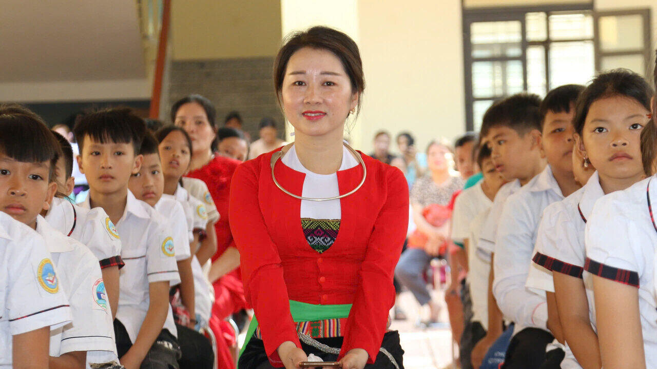 Teachers in traditional national costumes attend the Opening Ceremony. Photo: Minh Nguyen