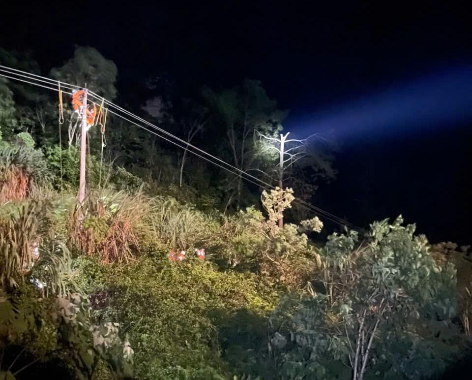 orange-shirted workers perched precariously on high poles to carry out the task of "rescuing electricity".