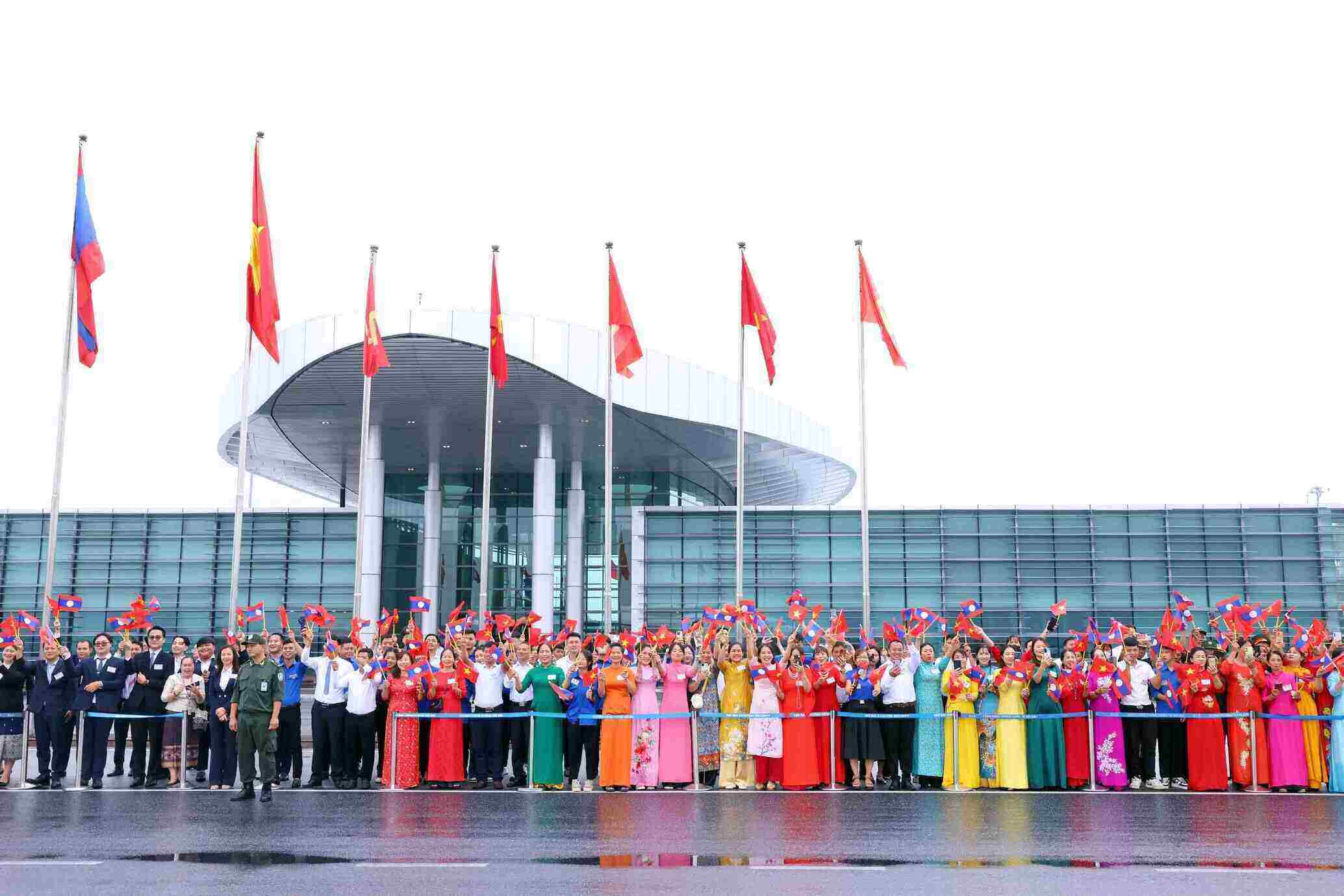 Crowds of people welcomed the Lao General Secretary and President and his wife at Noi Bai International Airport. Photo: VNA