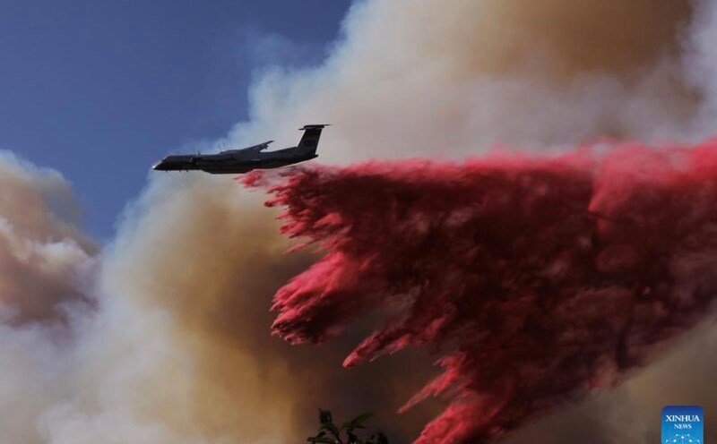 US aircraft spray fire retardant from above. Photo: Xinhua