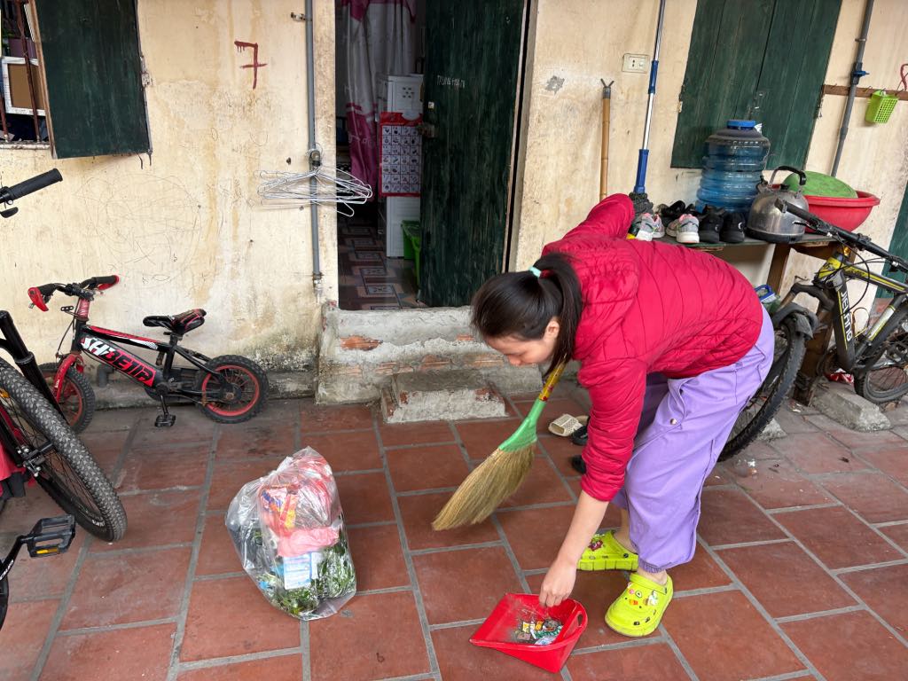 Female worker Dinh Bao Yen in front of her family's main rented room. Photo: Bao Han