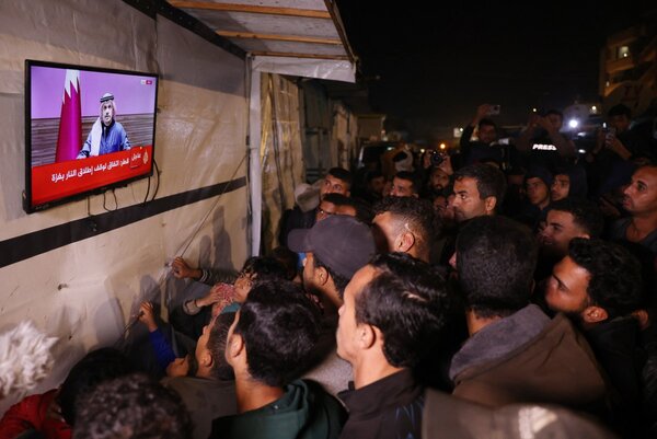 People in Gaza watch the Qatari Prime Minister speak about the ceasefire agreement between Israel and Hamas. Photo: AFP