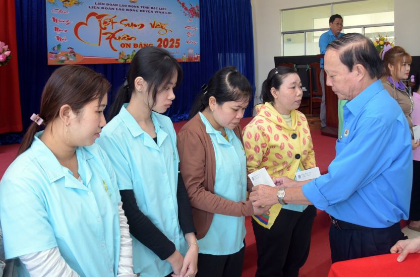 Chairman of Bac Lieu Provincial Federation of Labor Nguyen Van Khanh presents gifts to union members and disadvantaged workers in Vinh Loi district. Photo: Nhat Ho