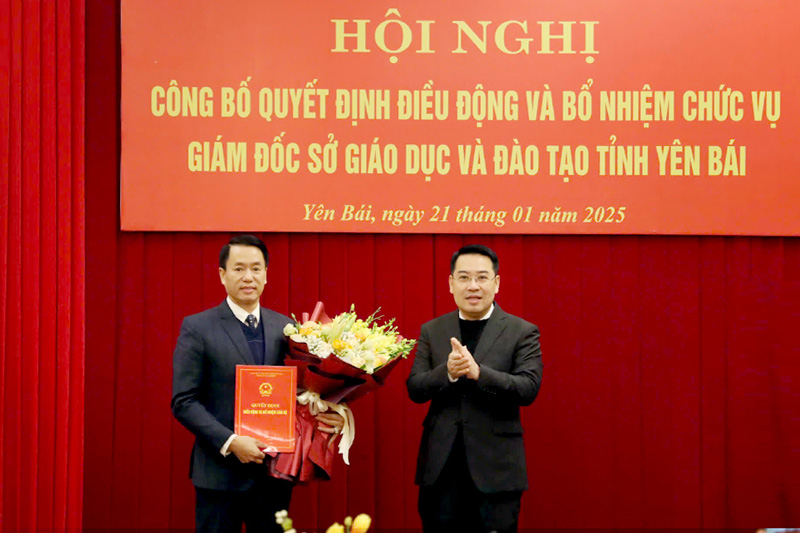 Chairman of Yen Bai Provincial People's Committee Nguyen Tuan Anh presented the decision and flowers to congratulate the new Director of the Department of Education and Training Luyen Huu Chung. Photo: Thanh Chi