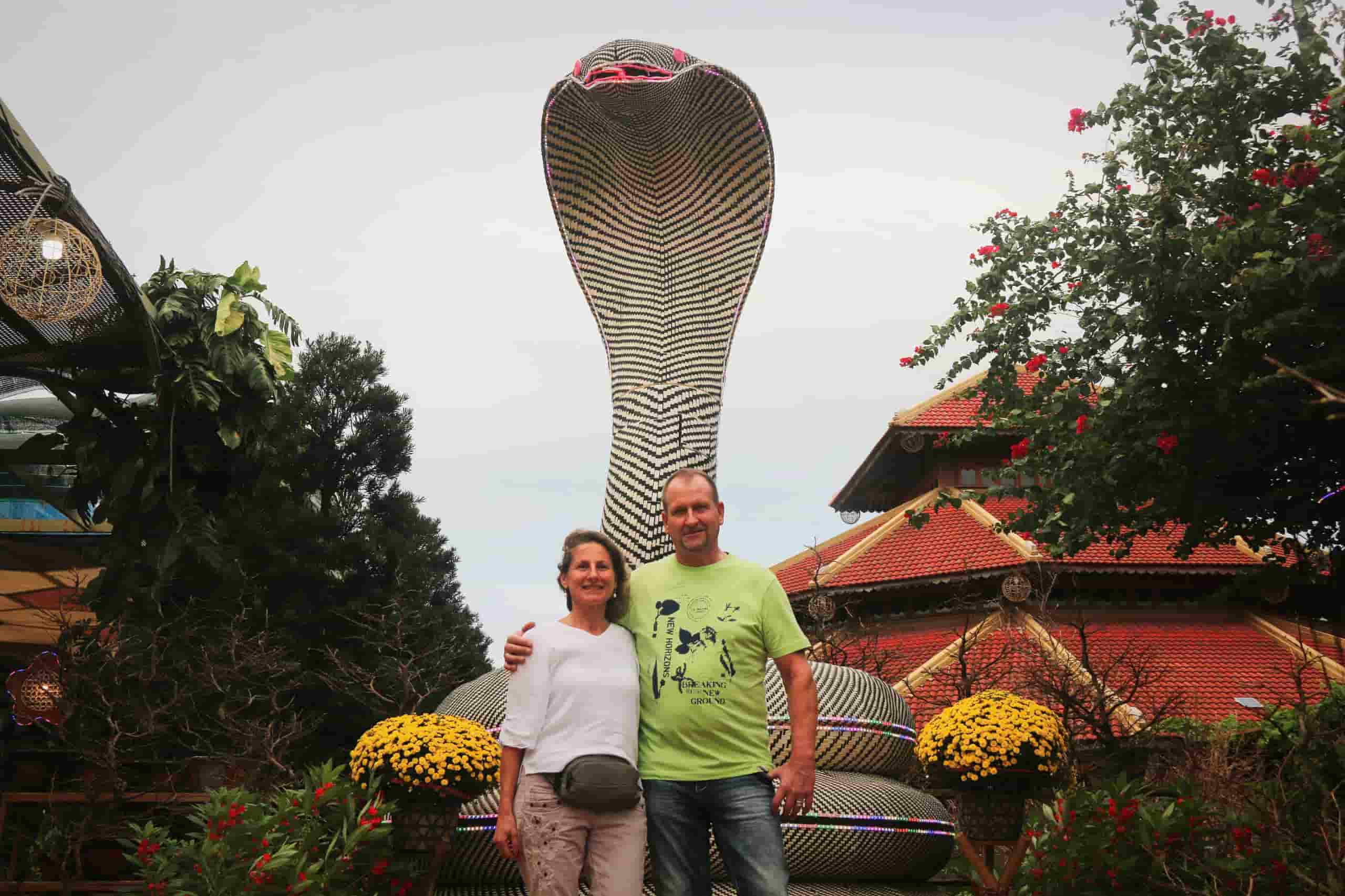 Tourists visiting Truong Son craft village in Nha Trang enjoy checking in with the snake mascot. Photo: Binh Quy