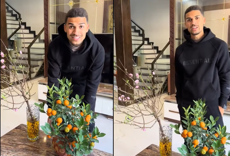 Hendrio happily shows off the Tet decorations he just bought. Photo cut from video