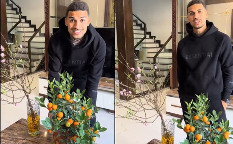 Hendrio happily shows off the Tet decorations he just bought. Photo cut from video