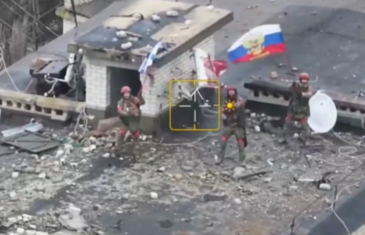 Russian soldiers wave flags, marking victory in Velikaya Novoselka, Ukraine. Screenshot from video