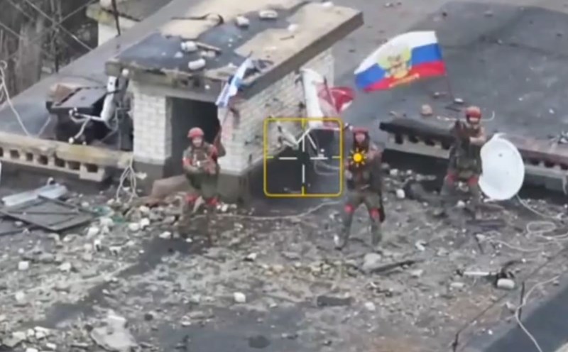Russian soldiers wave flags, marking victory in Velikaya Novoselka, Ukraine. Screenshot from video