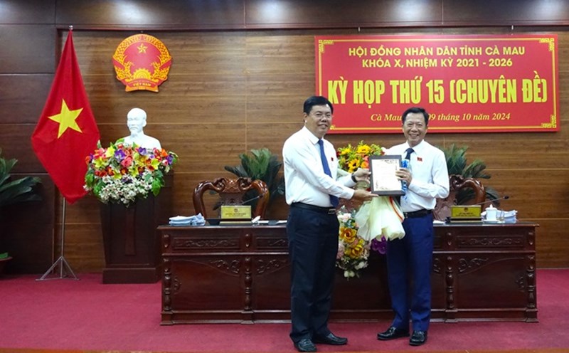 Member of the Party Central Committee, Secretary of the Provincial Party Committee, Chairman of the Provincial People's Council Nguyen Tien Hai of Ca Mau (left) presented flowers to congratulate Mr. Duong Huynh Khai on his retirement under the regime. Photo: Ca Mau Provincial People's Committee