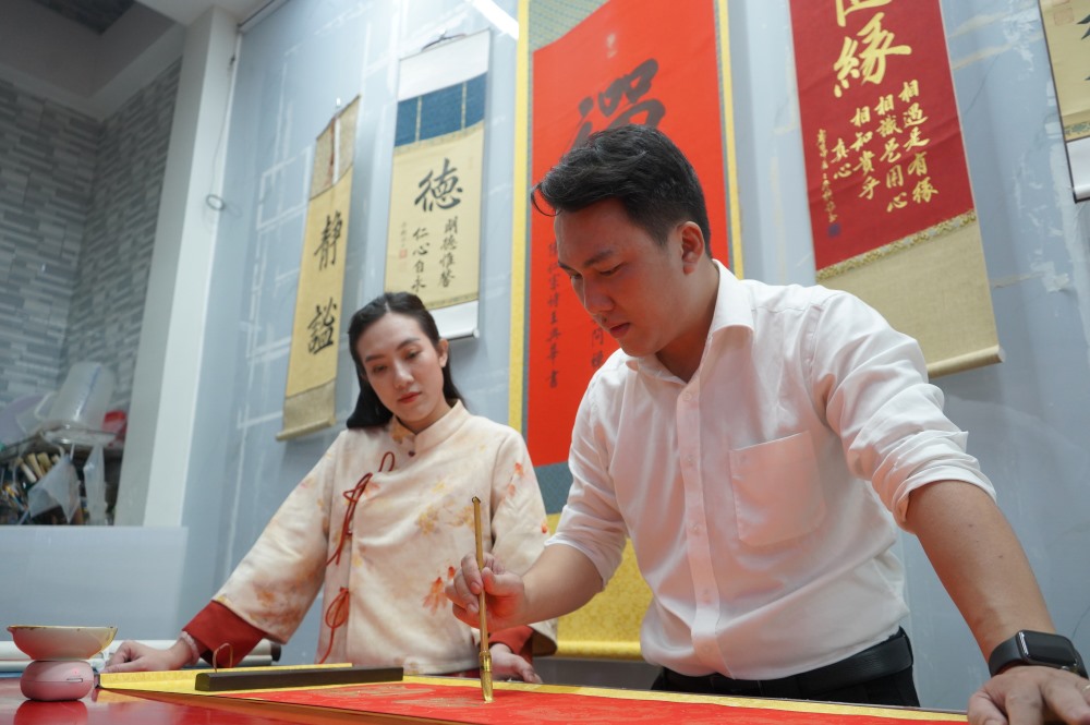 Young man keeps the soul of calligraphy, spreading traditional spring colors