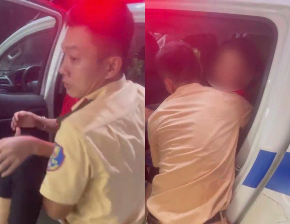Canh sat Giao thong dua be trai len xe dac chung de dua den benh vien cap cuu. Anh: Cong an 