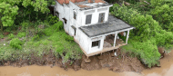 A 96-year-old woman in Thanh Long Islet, Quoi Thien Commune, had to stay at a relative's house because the landslide threatened her house. Photo: Hoang Loc