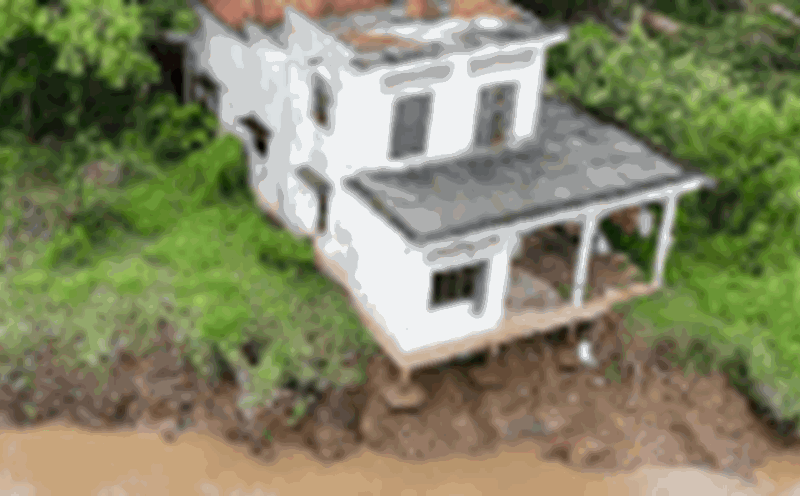 A 96-year-old woman in Thanh Long Islet, Quoi Thien Commune, had to stay at a relative's house because the landslide threatened her house. Photo: Hoang Loc