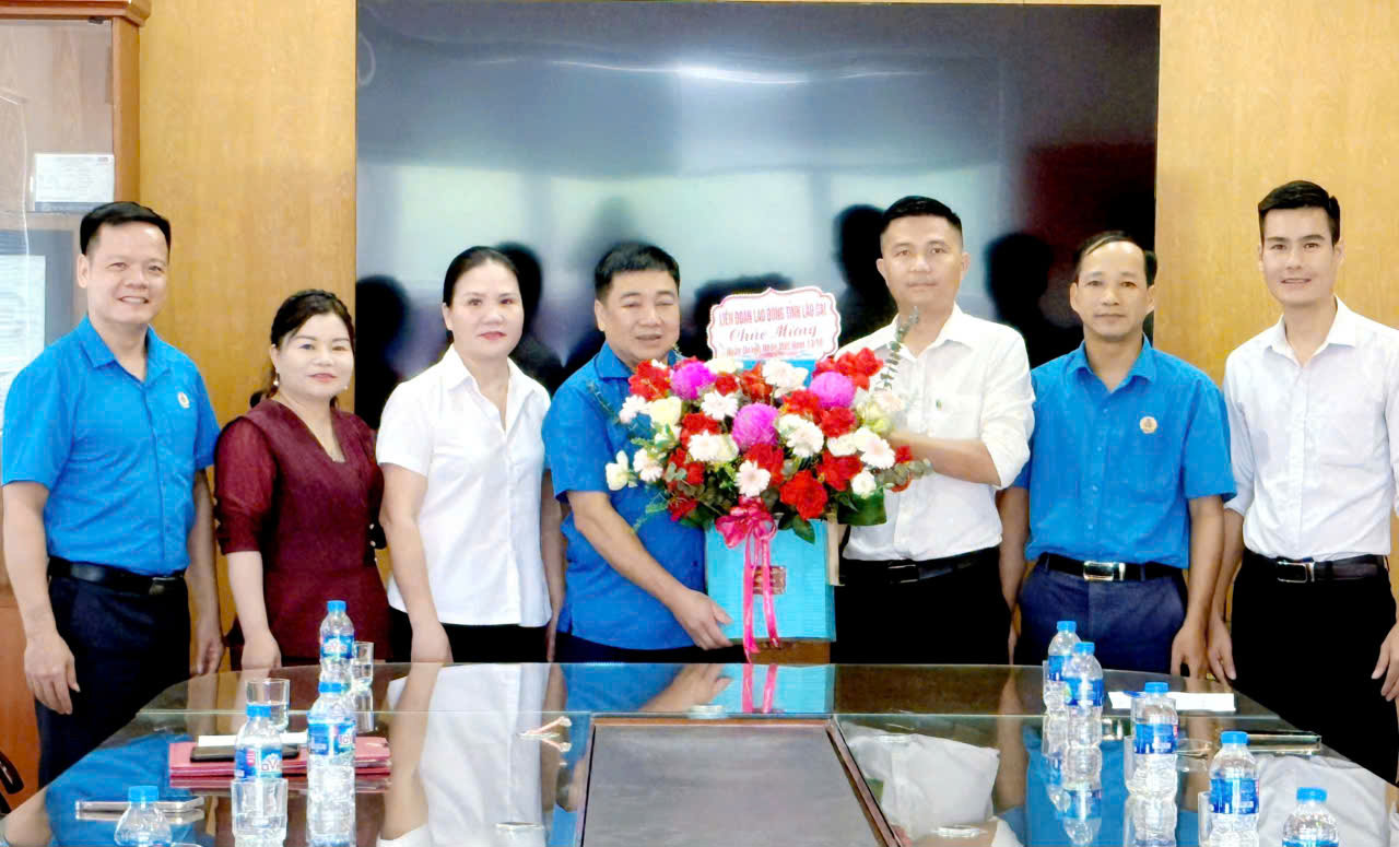 Ong Phan Huy Cuong - Pho chu tich Lien doan Lao dong tinh Lao Cai cung doan cong tac tang hoa chuc mung cac doanh nghiep. Anh: Bao Nguyen