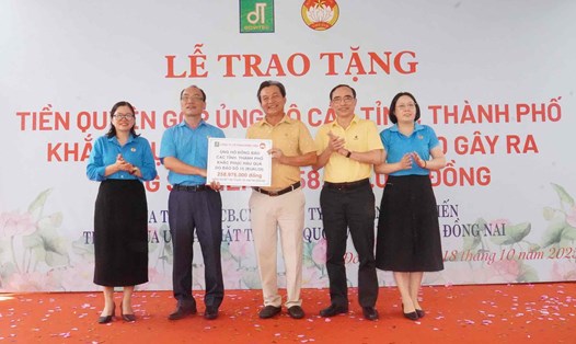 Đại diện Liên đoàn lao động tỉnh Đồng Nai nhận biểu trưng số tiền gần 260 triệu đồng của cán bộ, công nhân viên Công ty CP Đồng Tiến ủng hộ người dân khắc phục hậu quả bão số 10. Ảnh: HAC