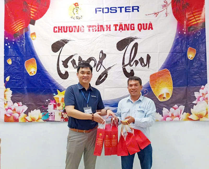 Mr. Tran Van Quang - Chairman of the Trade Union of Foster Quang Ngai Electronics Co., Ltd. (left) - presented gifts to union members. Photo: Xuan Quang