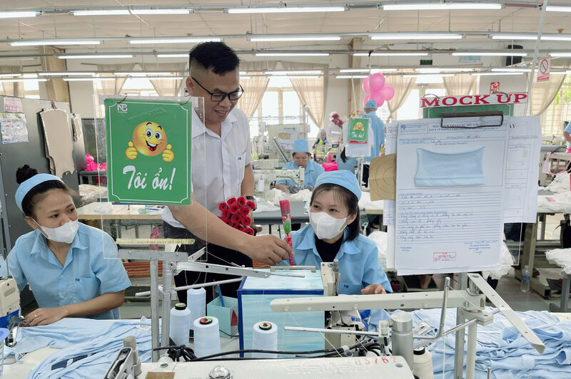 Le 20 octobre M. Nguyen Hoa - president du syndicat de base de l'entreprise de confection Tuy Phong - a offert des fleurs et felicite les membres du syndicat et les travailleurs de l'unite. Photo : Duc Lam