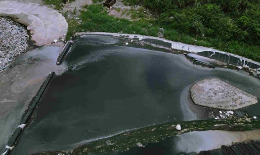 Nước thải từ bãi rác thung Quèn Khó chảy ra khu vực đường nội bộ bốc mùi hôi thối. Ảnh: Nguyễn Trường