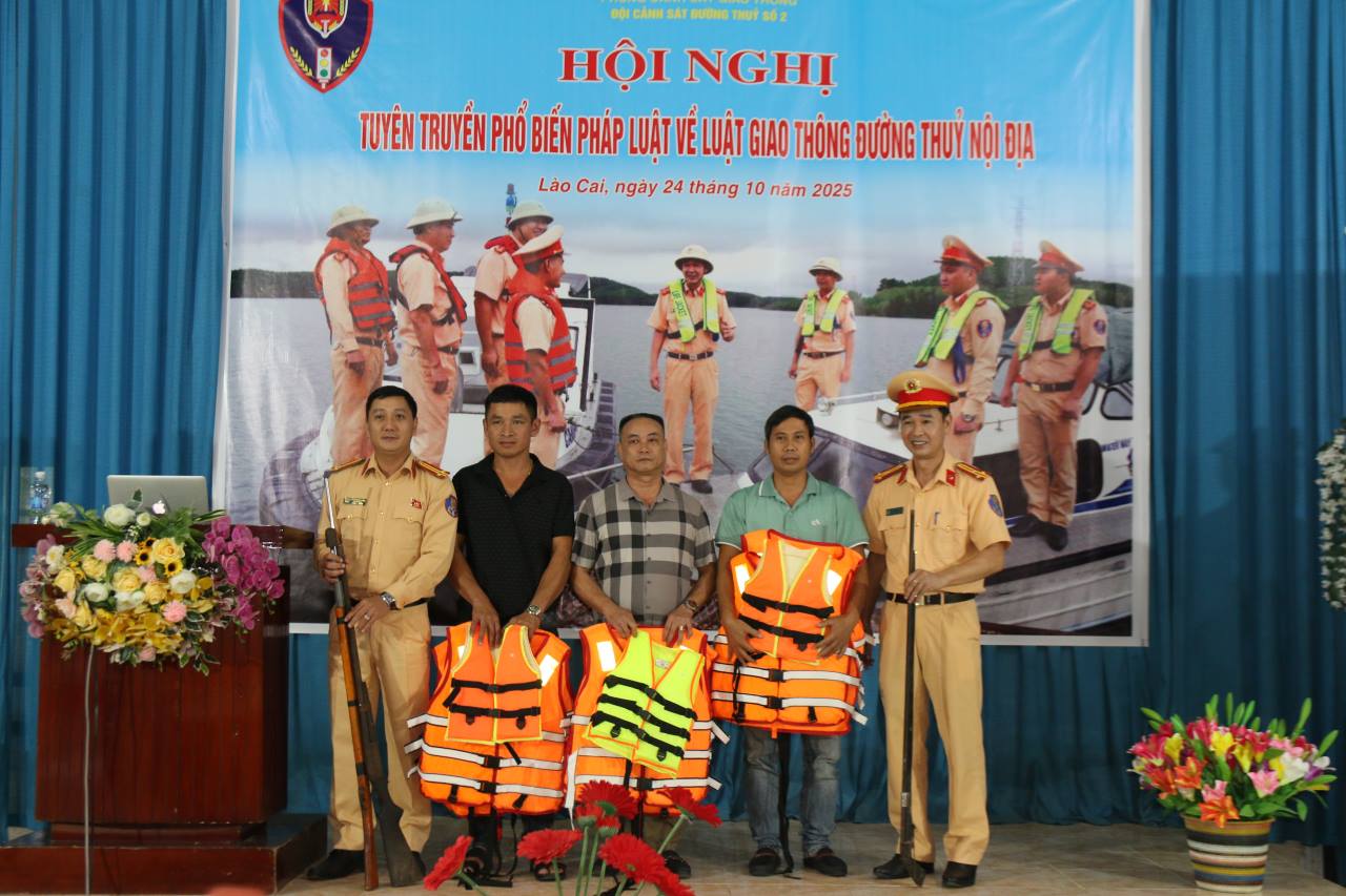 The waterway traffic police force presented life jackets to households who voluntarily handed over weapons. Photo: Van Duc