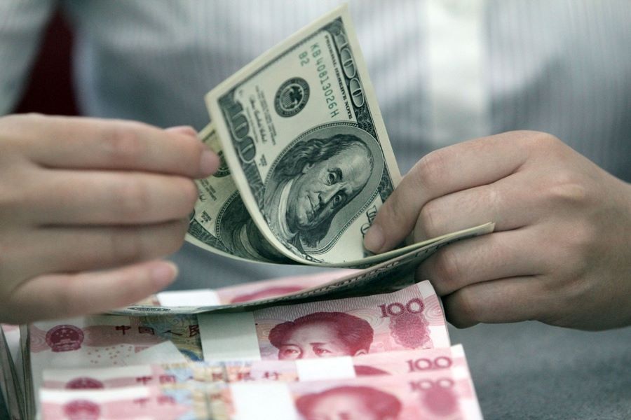 USD and yuan. Photo: Xinhua