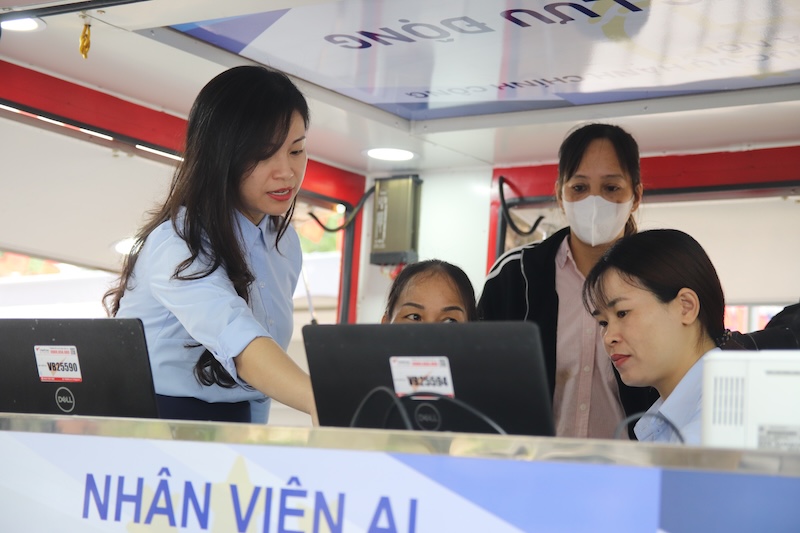 Ba Hoang Hien Hanh - Phu trach phong Tai cau truc va To chuc bo phan mot cua, Trung tam Phuc vu hanh chinh cong TP Ha Noi, huong dan nguoi dan thuc hien mot so thu tuc hanh chinh. Anh: Hoang Xuyen