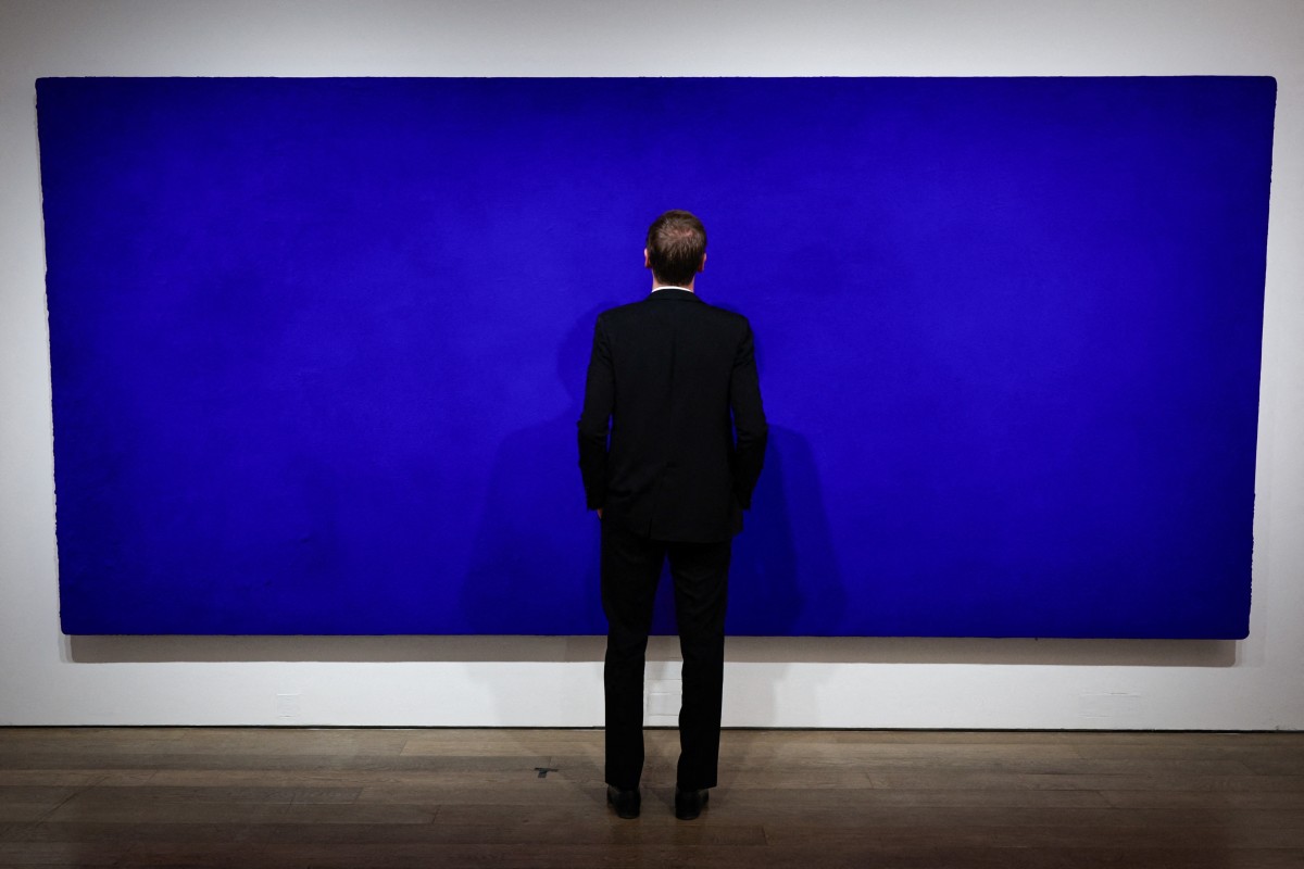 크리스티 경매 회사 직원이 파리 크리스티 경매 회사에 전시된 프랑스 화가 이브 클라인의 캘리포니아 그림을 보고 있습니다. 영국: AFP
