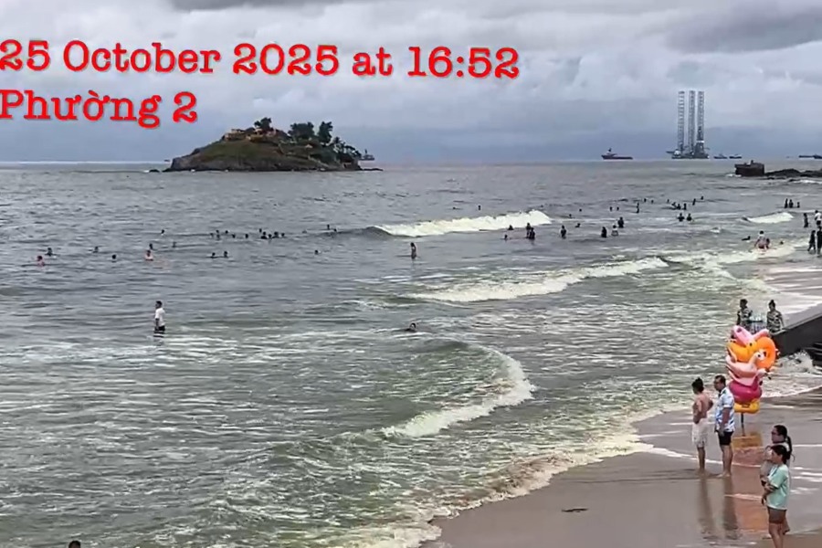 Nhieu nguoi van tam bien o Bai Sau (Vung Tau) chieu 25.10 du nuoc bien co mau xanh. Luc luong cuu ho van ung truc de dam bao an toan cho khach tam bien. Anh: Pham Khac To