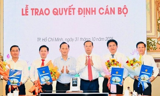 Phó Chủ tịch Thường trực UBND TPHCM Nguyễn Văn Thọ và Phó Bí thư Đảng ủy UBND TPHCM Trần Văn Nam trao quyết định điều động, bổ nhiệm và tặng hoa chúc mừng Ban Giám đốc Trung tâm Phát triển quỹ đất TPHCM. Ảnh: hcmcpv.org.vn