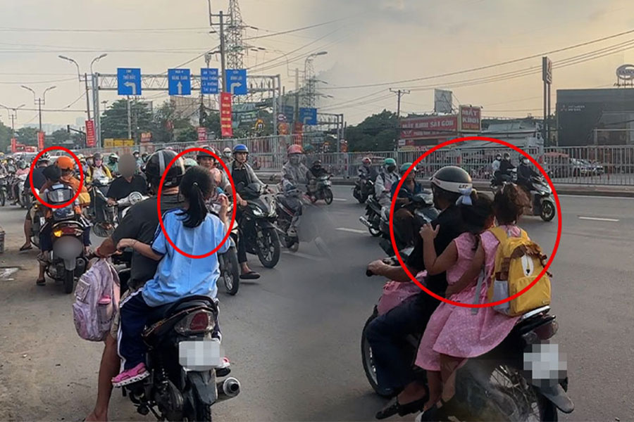 호치민시 13번 국도에서 헬멧을 쓰지 않은 채 역주행하는 학부모