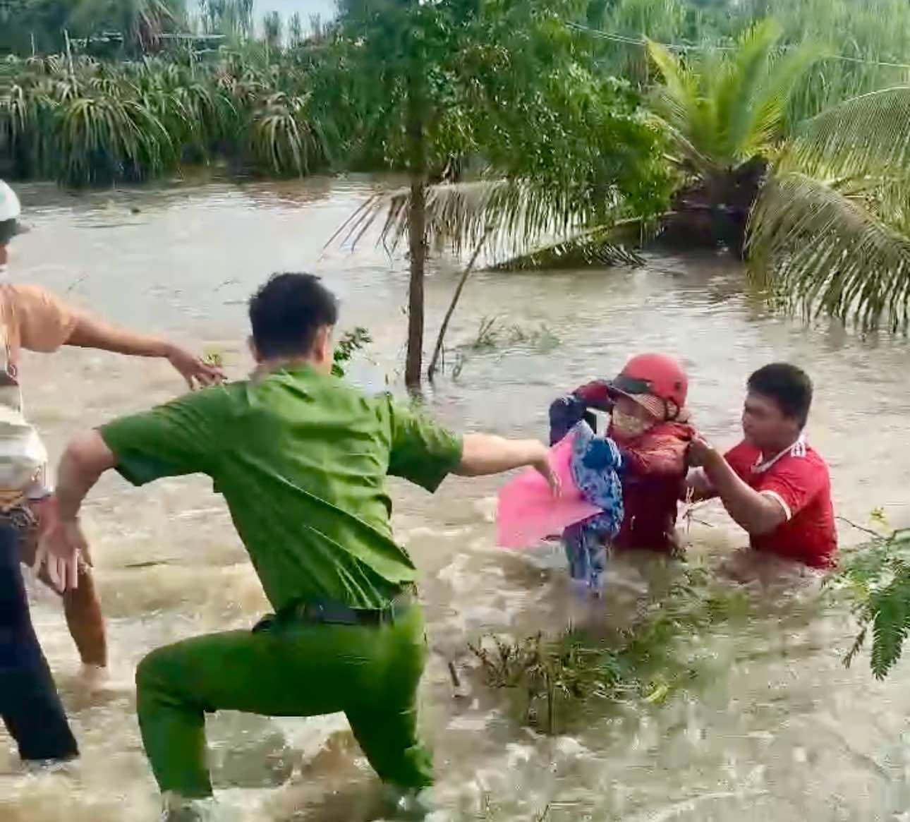 Nguoi phu nu bi nuoc cuon troi duoc ho tro kip thoi. Anh: Pham Duy