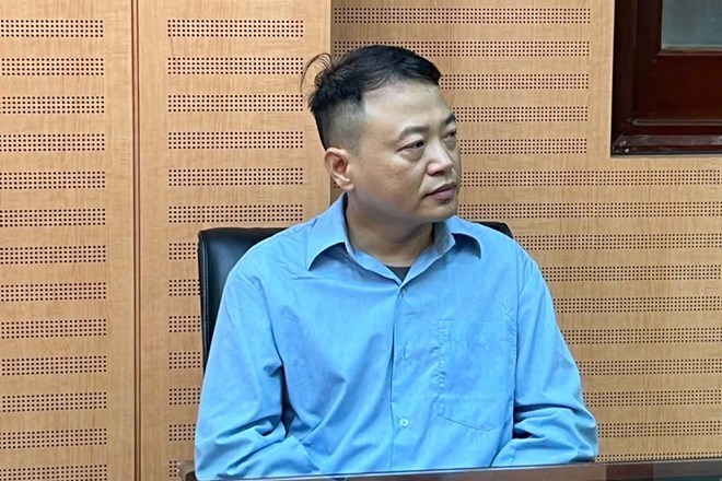 Shark Binh at the investigation agency. Photo: Hanoi Police