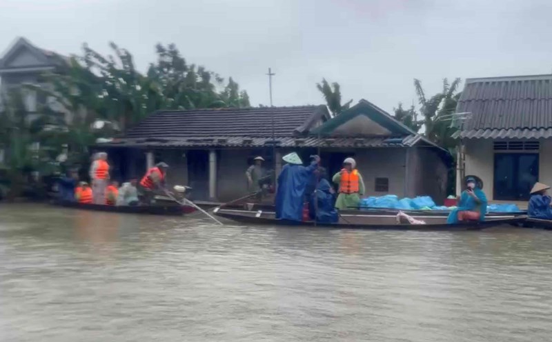 Taking a boat in a flooded field provides hot rice to people in flooded areas. Photo: H.Nguyen