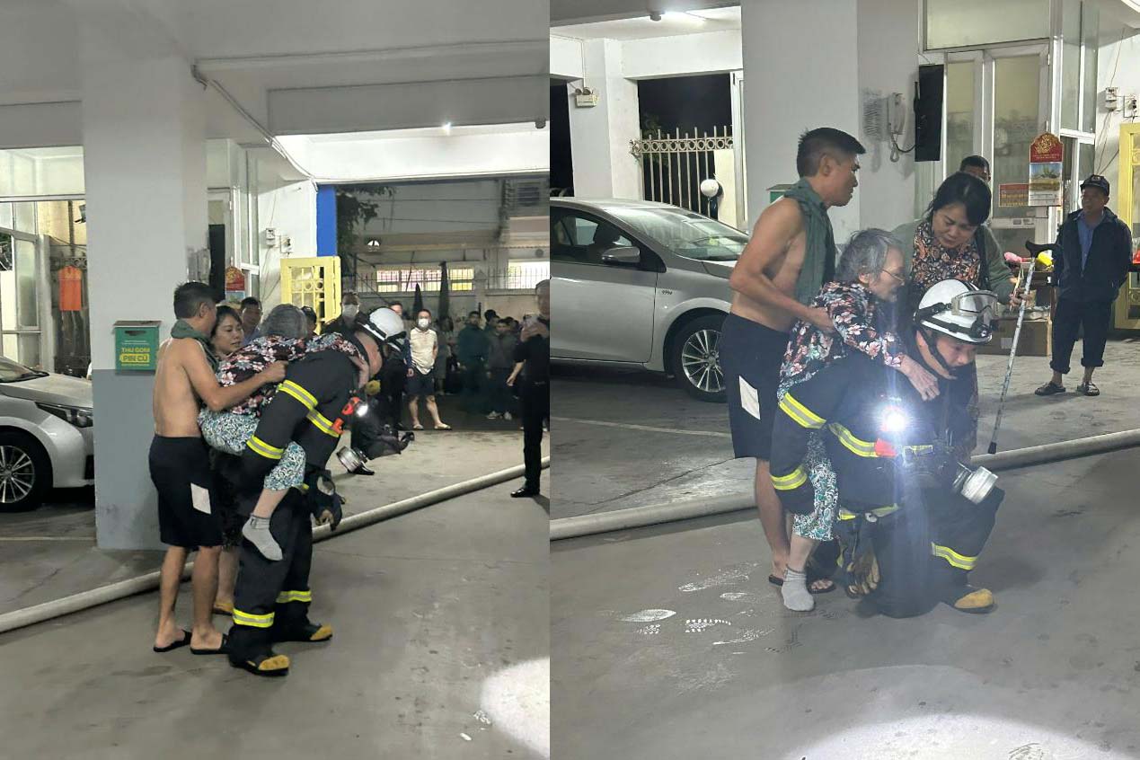 The authorities promptly rescued 2 people in the fire at the 4th floor of apartment building 15B Dong Quan. Photo: Hanoi Police