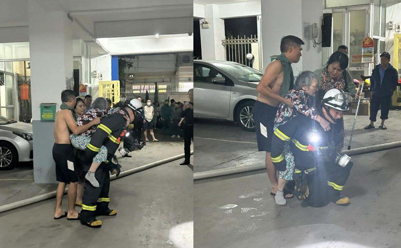 The authorities promptly rescued 2 people in the fire at the 4th floor of apartment building 15B Dong Quan. Photo: Hanoi Police