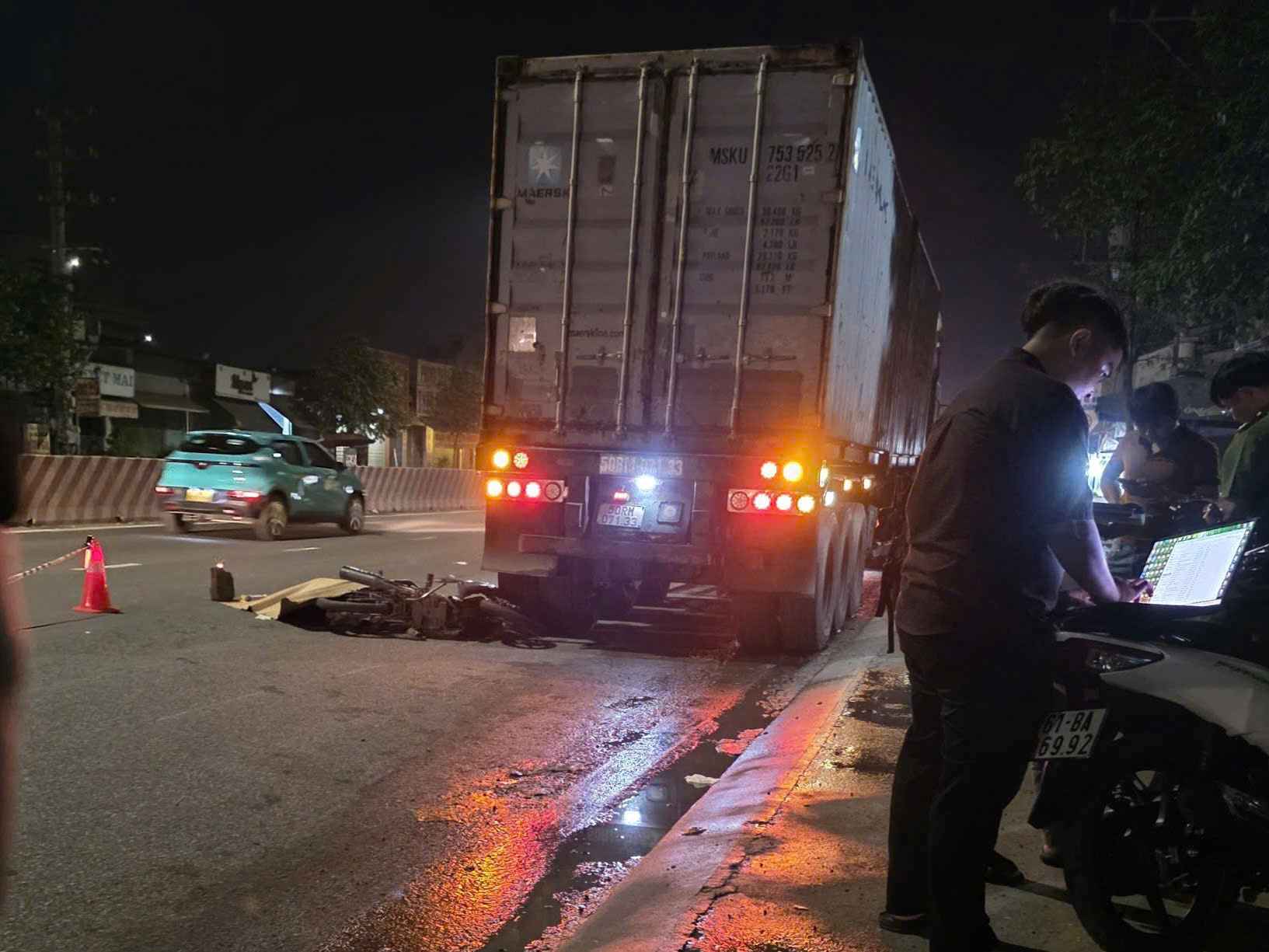 The scene of the accident between a motorbike and a container truck that killed 1 person. Photo: Dinh Trong