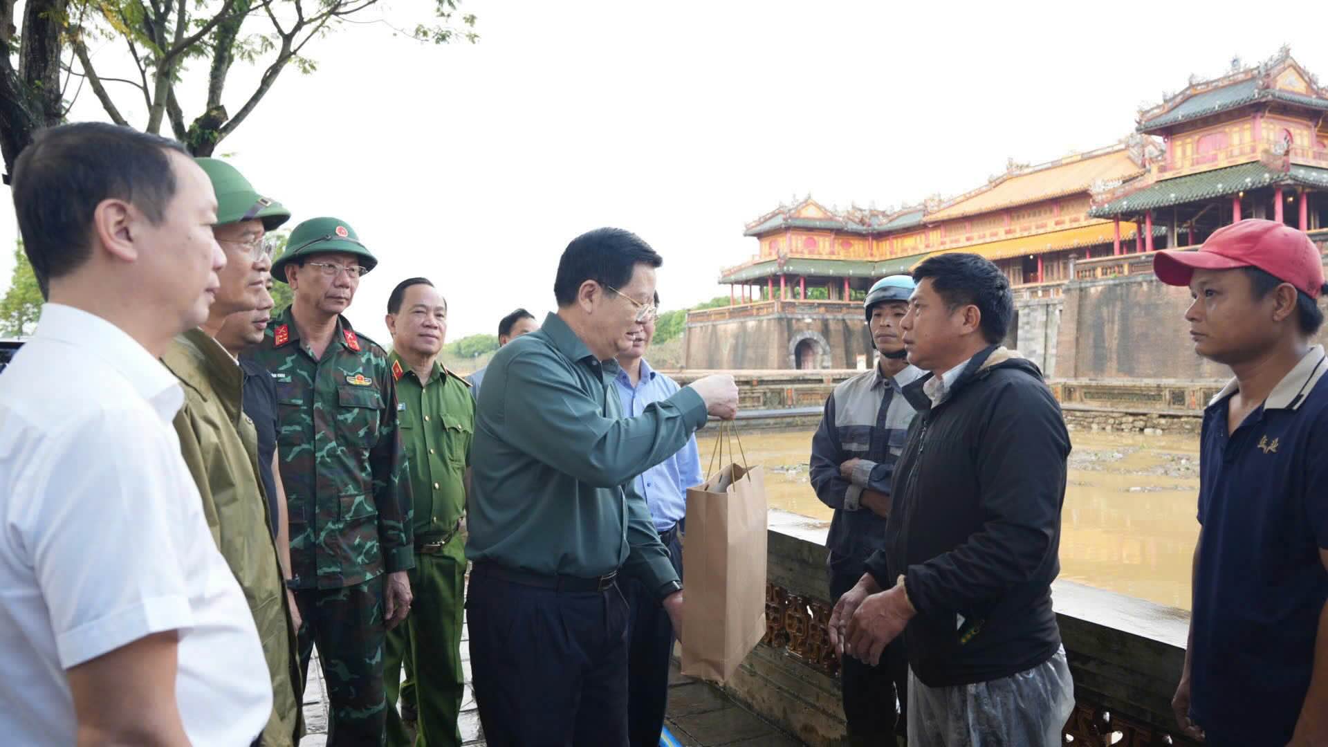 Pho Thu tuong Mai Van Chinh tang qua dong vien nhan vien Trong tam Bao ton Di tich Co do Hue don dep, bao ve di tich trong mua lu. Anh: N. Hieu.
