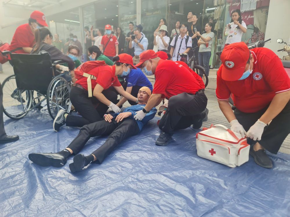 Nhan vien y te so cuu “nan nhan” duoc dua ra khoi khu vuc chay trong buoi dien tap. Ảnh: Thanh Tau